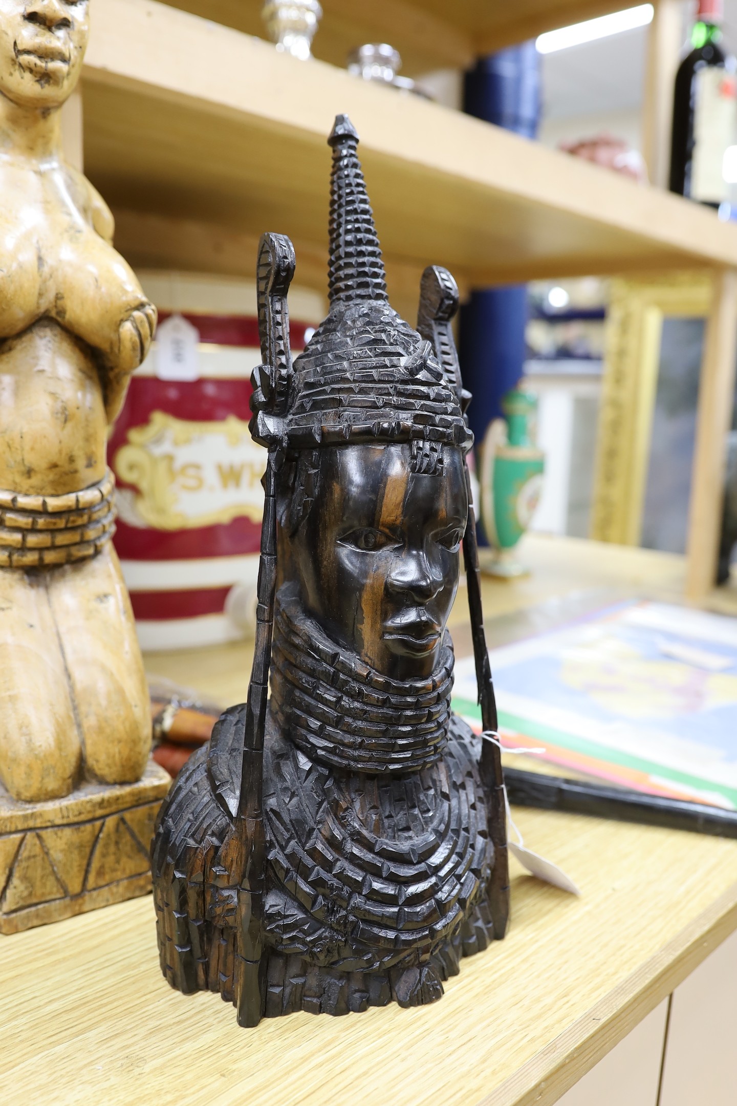 A group of African carvings, and two knives within sheaths, tallest figure 51cm